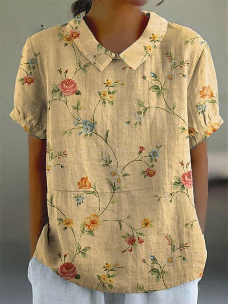 Camicia donna in lino beige con colletto, maniche corte e stampa floreale colorata. Elegante e casual, perfetta per la moda estiva.