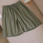 Pantaloncini corti verdi in cotone, stile casual, con elastico in vita e tasche laterali, ideali per l'estate e il tempo libero.