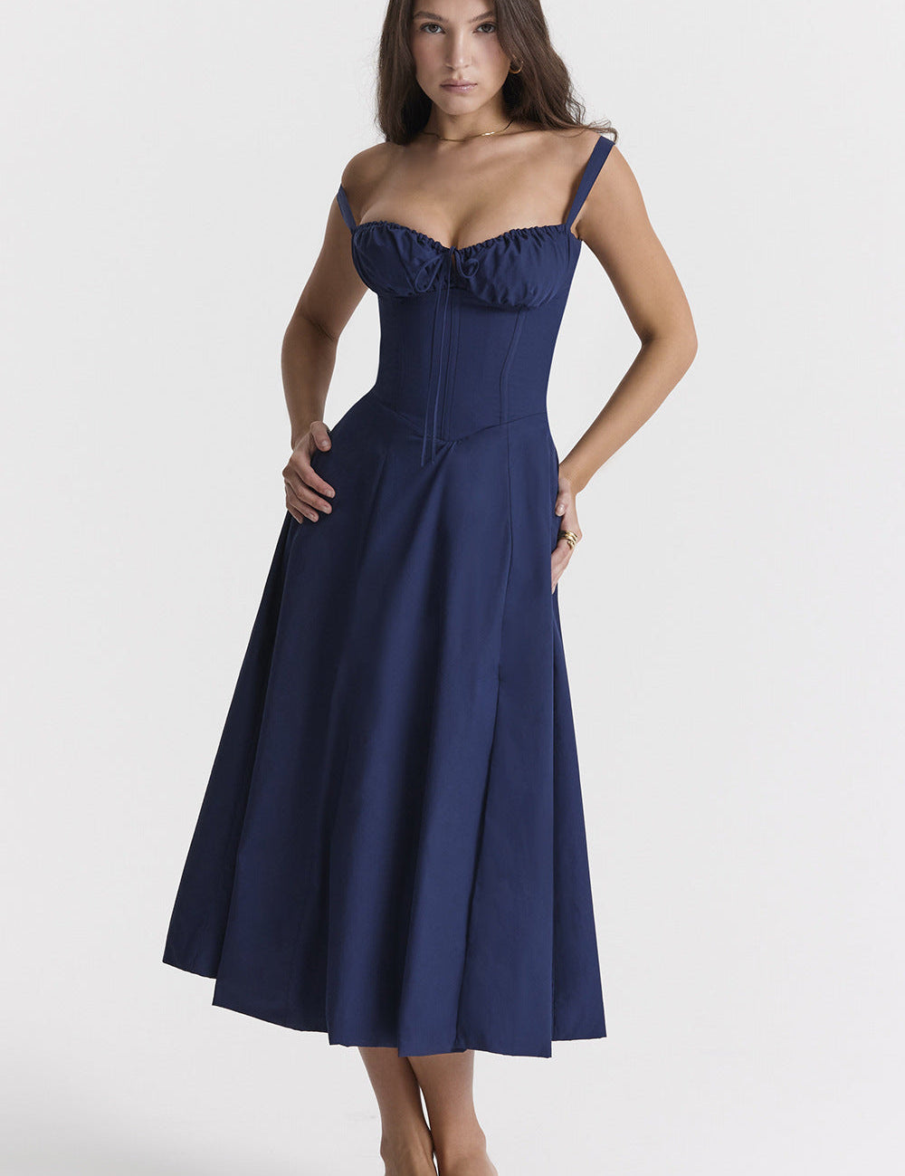 Abito lungo blu scuro elegante con spalline sottili e corpetto aderente, perfetto per eventi serali. Donna in posa su sfondo bianco.