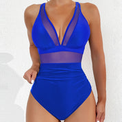Costume intero blu donna, design con inserti in rete trasparente, scollo a V profondo, moda mare estate, elegante e moderno.