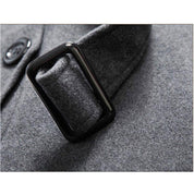Cappotto in lana grigia con fibbia nera, dettaglio elegante e moderno, ideale per moda invernale uomo. Tessuto caldo e di alta qualità.