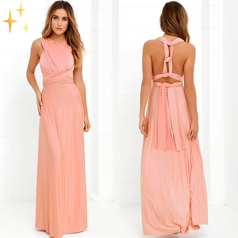 Abito lungo elegante rosa pesca con scollo incrociato e schiena scoperta, perfetto per cerimonie e serate glamour. Tessuto fluido e design sofisticato.