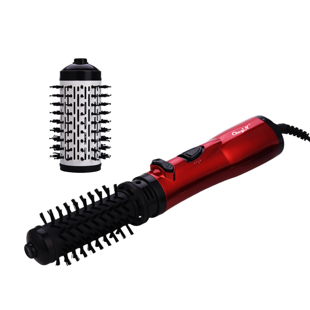 Spazzola rotante elettrica rossa con accessorio intercambiabile, ideale per styling capelli. Strumento per acconciature professionali e domestiche.
