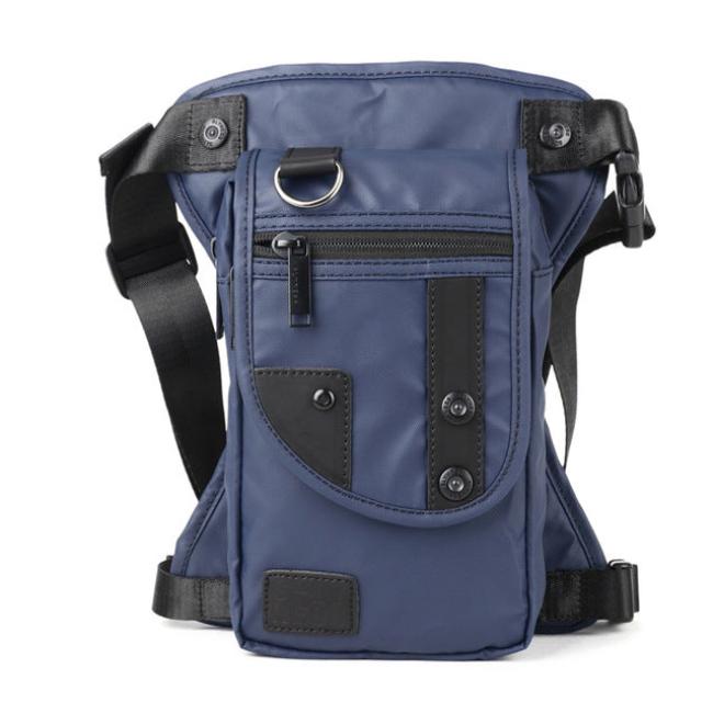 Marsupio a tracolla blu in nylon con tasche multiple, cerniere nere e dettagli in pelle. Design unisex, ideale per viaggi e attività all'aperto.
