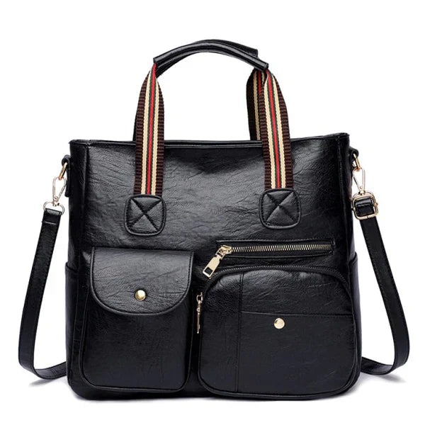 Borsa a tracolla in pelle nera con manici a righe, tasche frontali con zip e bottoni, design elegante e funzionale per donna.