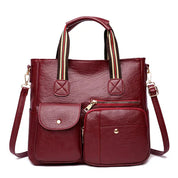 Borsa a tracolla in pelle rossa con tasche multiple, manici a righe, design elegante e funzionale, perfetta per moda donna e uso quotidiano.