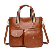 Borsa a tracolla in pelle marrone con manici a righe, tasche frontali con zip e bottoni. Elegante e pratica per uso quotidiano.