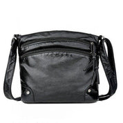 Borsa a tracolla in pelle nera, design elegante con cerniere multiple, ideale per donna. Accessorio moda versatile e pratico.