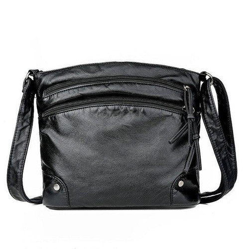 Borsa a tracolla in pelle nera, design elegante con cerniere multiple, ideale per donna. Accessorio moda versatile e pratico.