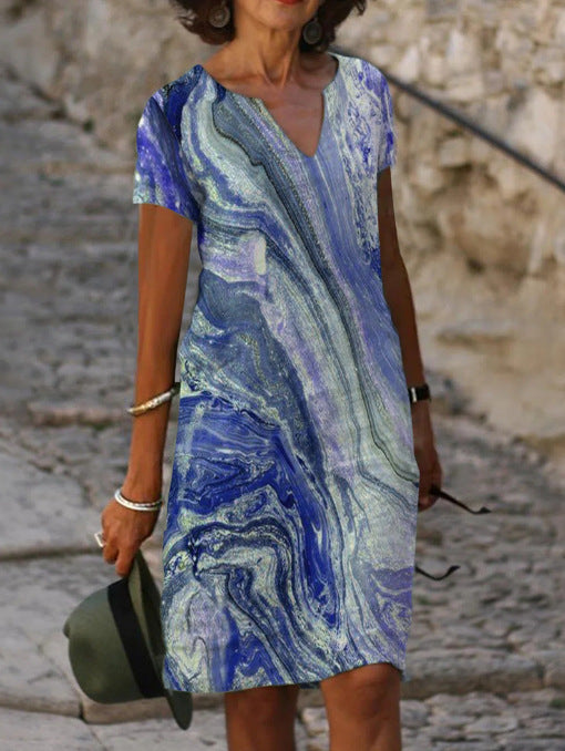 Abito estivo donna, fantasia marmo blu e bianco, scollo a V, maniche corte. Moda casual elegante, perfetto per passeggiate estive.