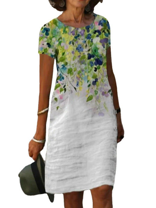 Abito estivo donna, manica corta, stampa floreale colorata su sfondo bianco, casual elegante, perfetto per occasioni estive e giornate calde.