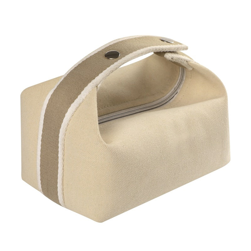 Borsa da toilette beige in tela con cerniera e manico rinforzato, design compatto e resistente, ideale per viaggi e organizzazione bagno.