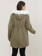 Donna con parka verde oliva, cappuccio con bordo in pelliccia bianca, vista posteriore. Giacca invernale elegante e calda.