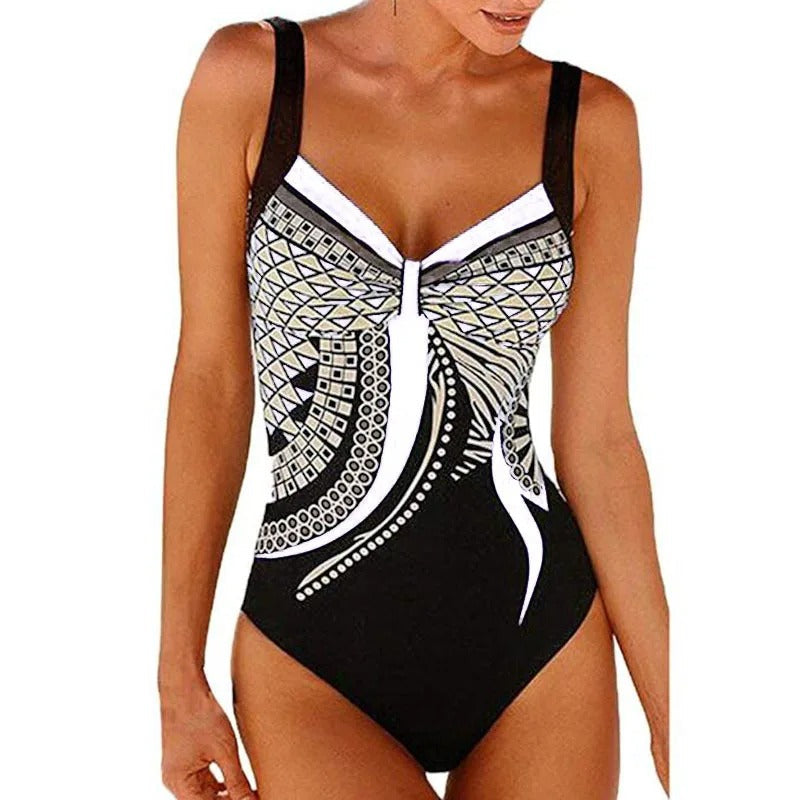 Costume intero donna nero con motivo geometrico bianco e dorato, spalline larghe, design elegante. Perfetto per spiaggia e piscina.