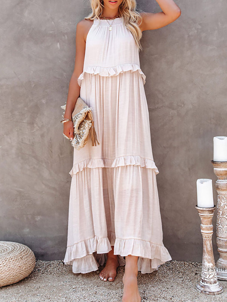 Abito lungo estivo donna in cotone bianco, senza maniche, con balze. Perfetto per occasioni casual. Accessoriato con borsa in paglia.
