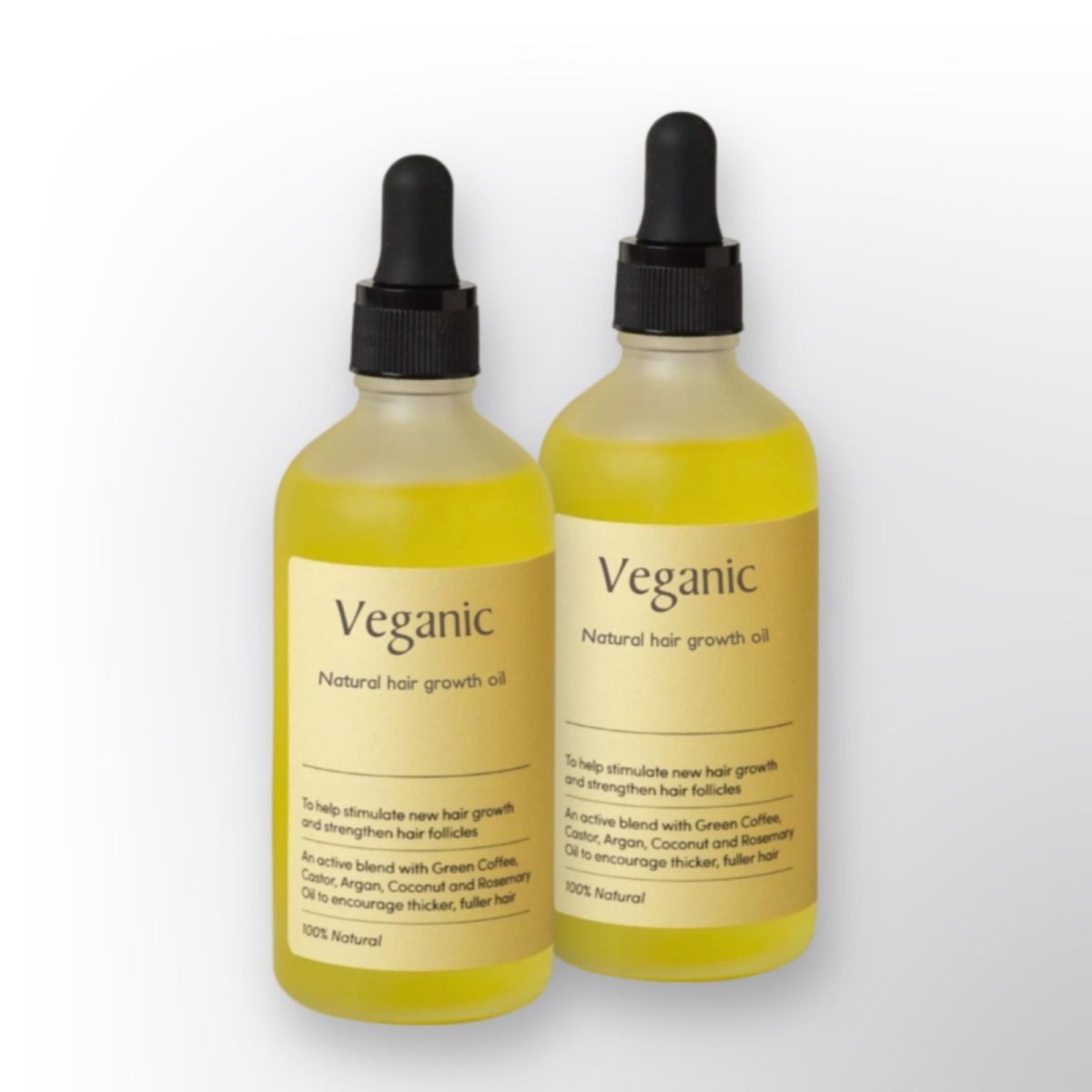 Due bottiglie di olio per crescita capelli Veganic con contagocce, etichetta beige, ingredienti naturali come caffè verde, ricino, argan e cocco.