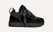 Scarpa da ginnastica nera invernale con suola spessa, lacci robusti e dettagli in tessuto e pelle. Design moderno e confortevole per il freddo.