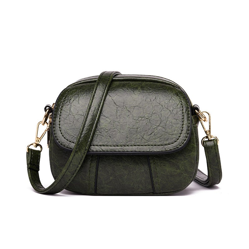 Borsa a tracolla verde in pelle sintetica, design compatto, chiusura a zip, dettagli dorati, ideale per moda donna, accessorio elegante e pratico.
