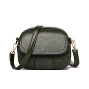 Borsa a tracolla verde in pelle sintetica, design compatto, chiusura a zip, dettagli dorati, ideale per moda donna e accessori eleganti.