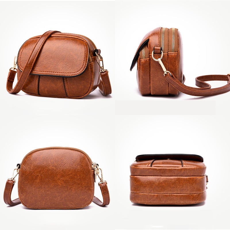Borsa a tracolla in pelle marrone, design elegante e compatto, con cerniera dorata e tasca frontale. Accessorio moda donna, versatile e chic.