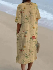 Abito lungo floreale donna in lino, maniche corte, colore beige, perfetto per look estivo casual in spiaggia. Elegante e comodo.
