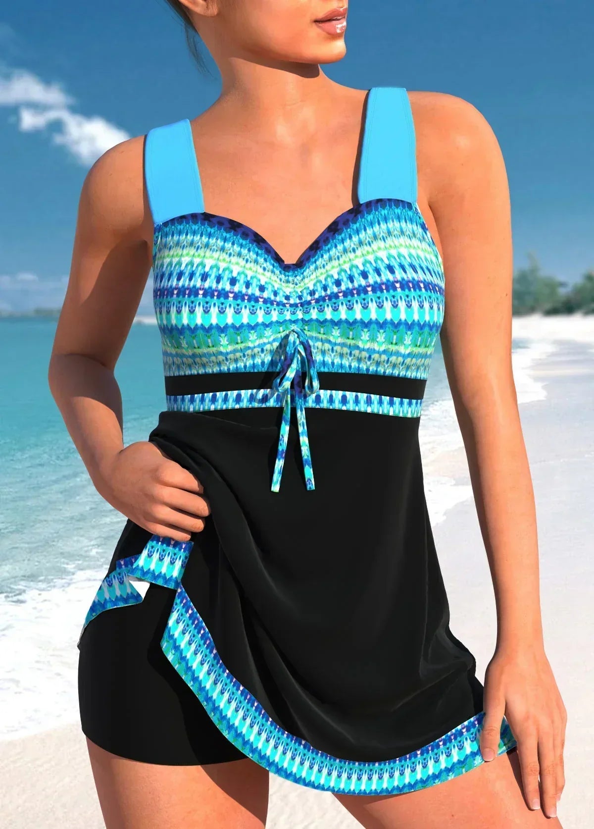 Donna in costume da bagno intero blu e nero con motivo geometrico, su spiaggia tropicale. Moda mare, abbigliamento estivo, vacanze al mare.
